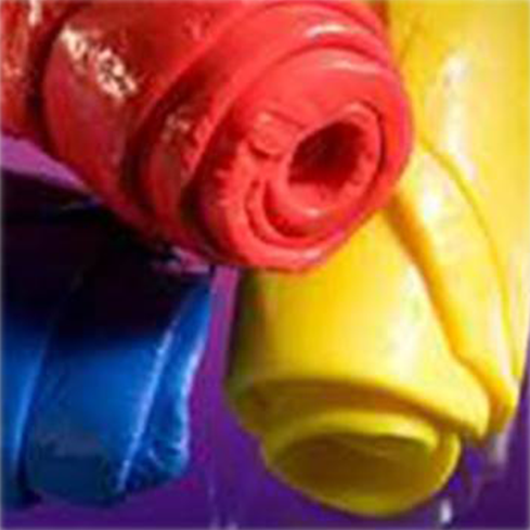 Three Rolls Of Colored Plastic In Red, Blue, And Yellow